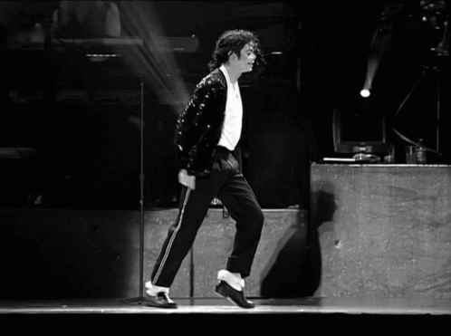 Michael Jackson smoothly glides backward with his iconic Moonwalk