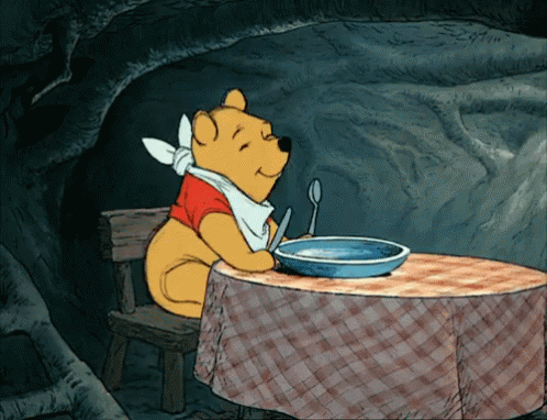 Winnie The Pooh joyfully dances with food on his mind. 